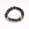 polished dark green obsidian bracelet with six gold rings framing four obsidian beads